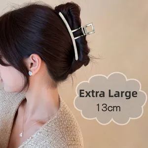 Silver extra large 13cm metal hair claw clip shown holding thick hair on a model