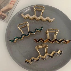 Elegant wavy metal claw clips set with acetate resin inserts in four stylish colors