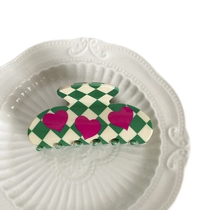 Green and white checkered hair claw clip with pink hearts made of acetate material