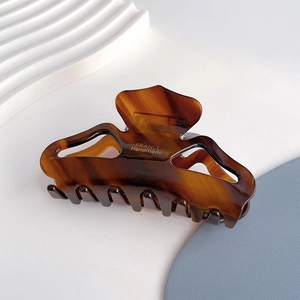 Detail of tortoise shell acetate hair claw with gold FRANCE Handmade lettering