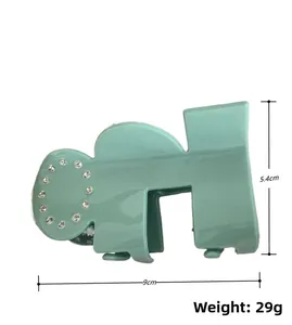 Detailed view of mint green acetate hair claw clip with rhinestones and 9cm size dimensions