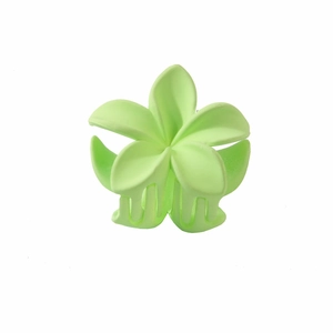 Detail of light green plumeria hair claw clip with matte finish and plastic teeth