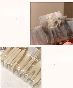Detail view of marble acetate hair claw showing high-quality spring and interlocking teeth