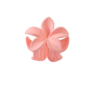 Close-up of pink matte plumeria flower hair claw clip with detailed petal texture
