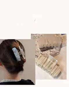 Close-up of square acetate claw clips with marble texture and sturdy metal springs