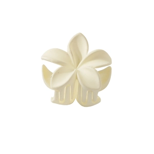 Detail of matte cream plumeria hair claw clip with rounded petals and smooth finish