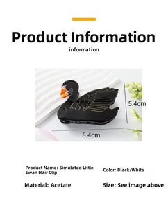Detail view of cellulose acetate swan hair claw clip with golden wing patterns