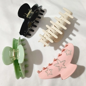 Set of four large acetate hair claw clips with rhinestone star patterns in multiple colors