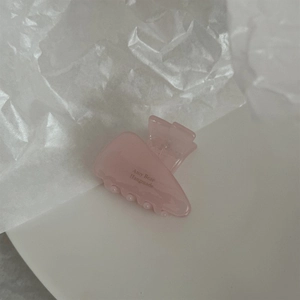 Detail of pink polished hair claw clip with Amy Bear Handmade text on a textured background