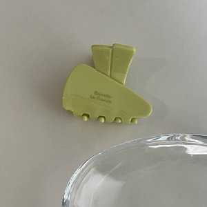 Close-up of a light green acetate hair claw clip with Barrette La France lettering