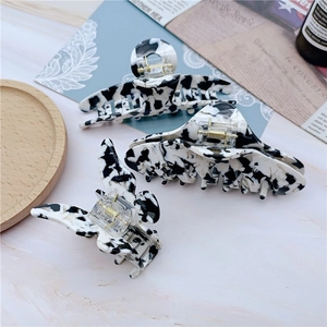 Three-piece acetate hair claw set with cow pattern and gold springs for vintage styling