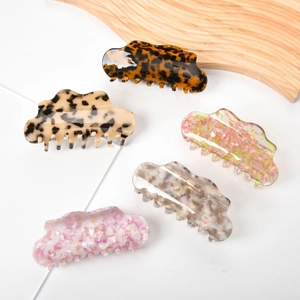 Detail view of 13cm acetate hair claws in five marble patterns and cloud shapes
