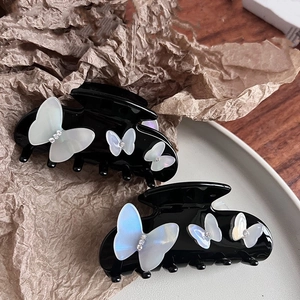 Elegant black butterfly claw clips with pearlescent resin wings and shiny rhinestones