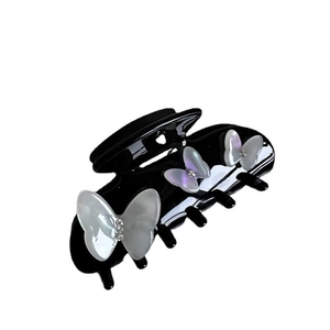 Elegant black claw hair clip with white pearlescent butterfly and rhinestone accents