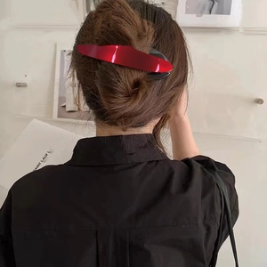 Elegant bright red acetate banana hair clip for women styled in a sleek ponytail