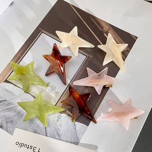 Star-shaped acetate hair clips set in marble and tortoiseshell patterns for women