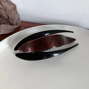 Detail of elegant bicolored dark brown and black hair claw clip with a glossy finish