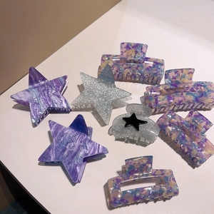Tortoiseshell acetate hair claws in purple and blue marble patterns with silver glitter