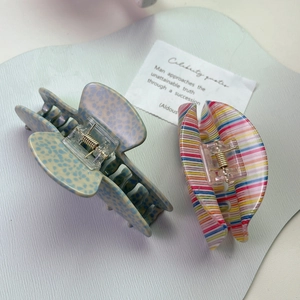 Minimalist acetate hair claw clips in blue spotted and rainbow striped patterns
