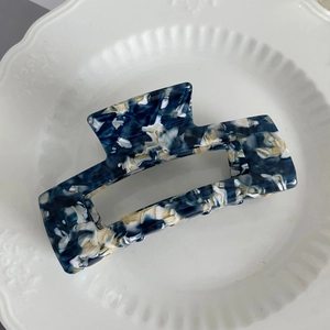 Detail of large marble blue acetate hair claw clip with rectangle hollow design