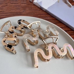 Chic M-shaped acetate hair claws in tortoiseshell and pearl finishes for women's updos
