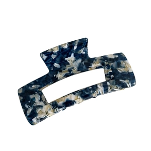Elegant rectangular acetate claw clip with blue and white marble pattern on white background
