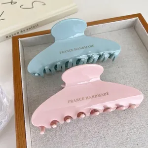 Set of large pastel blue and pink hair claw clips in glossy resin for elegant styling