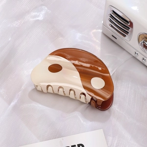 Retro Tai Chi acetate hair claw clip with brown and cream yin yang design on mesh