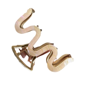 Minimalist M-shaped acetate hair claw clip with cream marble texture and gold metal base