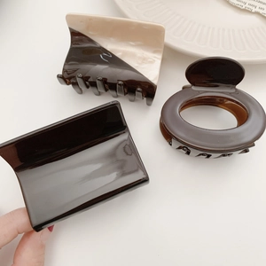 Three-piece brown and beige acetate hair claw clips in geometric shapes for women