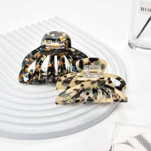 Close-up of tortoise shell pattern hair claw clips with golden metal springs