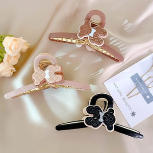Acetate bear hair claw clips in pink, black, and coffee brown with ribbon detail