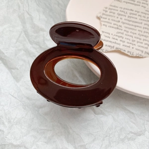 Elegant large coffee brown hollow hair claw clip with glossy resin finish for women