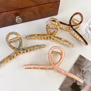 Set of four large acetate alloy hair claw clips in floral, marble, and solid colors