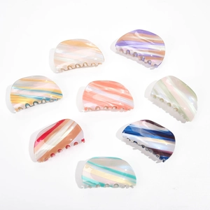 Detailed set of eight tortoiseshell acetate hair claws in various vibrant marbled patterns