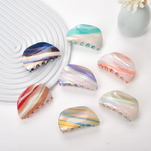 Collection of assorted acetate marble hair claws with elegant swirl patterns and glossy finish