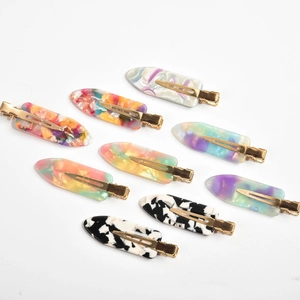 Collection of ten acetate hair clips in assorted marble and candy colors on gold metal bases