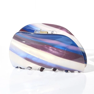Detail of large acetate hair claw clip showing blue and purple marble striped patterns