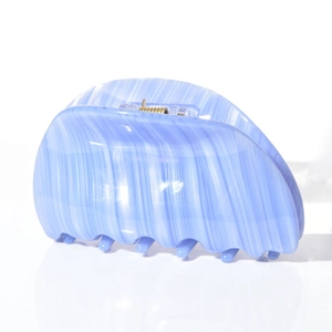 Detail of light blue marble acetate hair claw clip with unique vertical wavy texture
