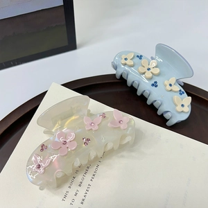 Elegant floral acetate hair claws with sparkling rhinestones in light blue and cream white