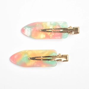 Close-up of candy-colored mosaic marble texture on two-piece set of acetate duckbill hair clips