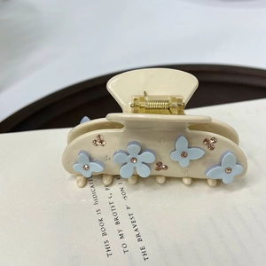 Vintage cream acetate hair claw clip with light blue floral accents and pink rhinestones