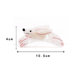 Detailed view of white marble acetate rabbit hair claw with size markings 10.5cm x 4cm