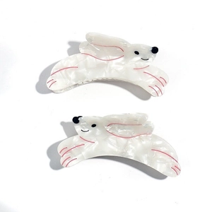 Close-up of rabbit hair clips in cream acetate with marble texture and pink details