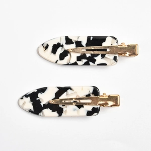 Detail of marble pattern acetate hair clips with gold metal spring-loaded alligator base