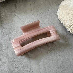 Detail of pink marble pattern acetate hair claw clip with France Hand Made engraving