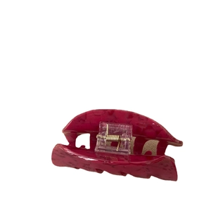 Large dark red marble texture hair claw clip with golden metal spring on white background