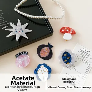 Artistic acetate hair clips featuring quirky mushroom and star shapes in oil painting style