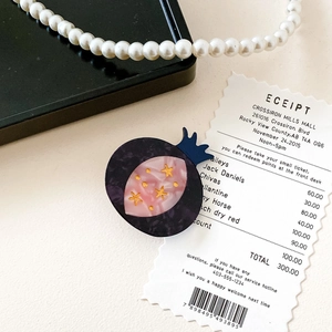 Detailed top view of a marble-textured mushroom hair clip with golden star accents