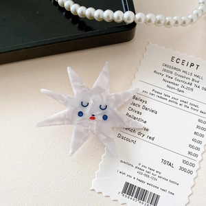 Artistic star-shaped acetate hair clip with marble texture and cute smiling face design